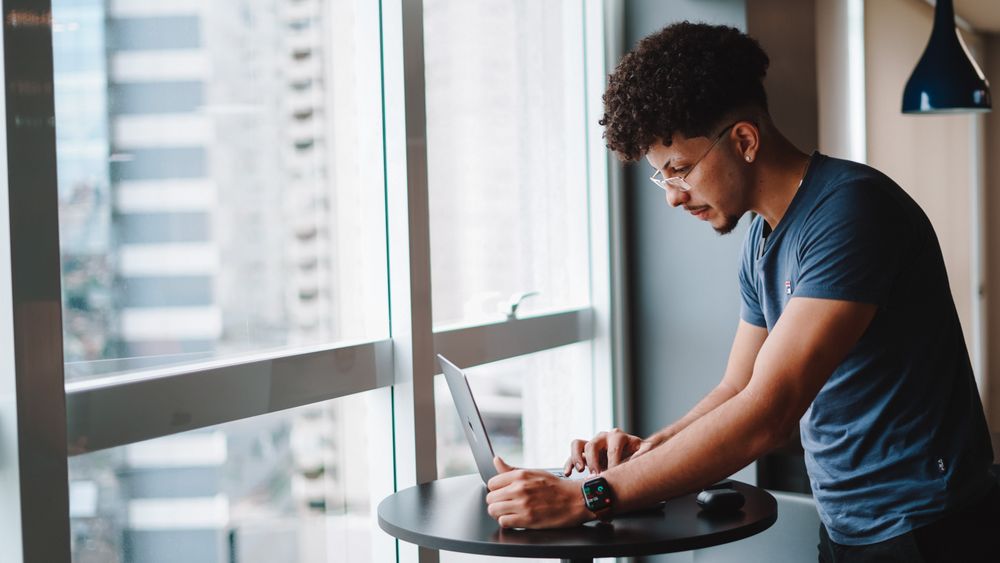 A developer at a laptop, whose submission the model reads in full