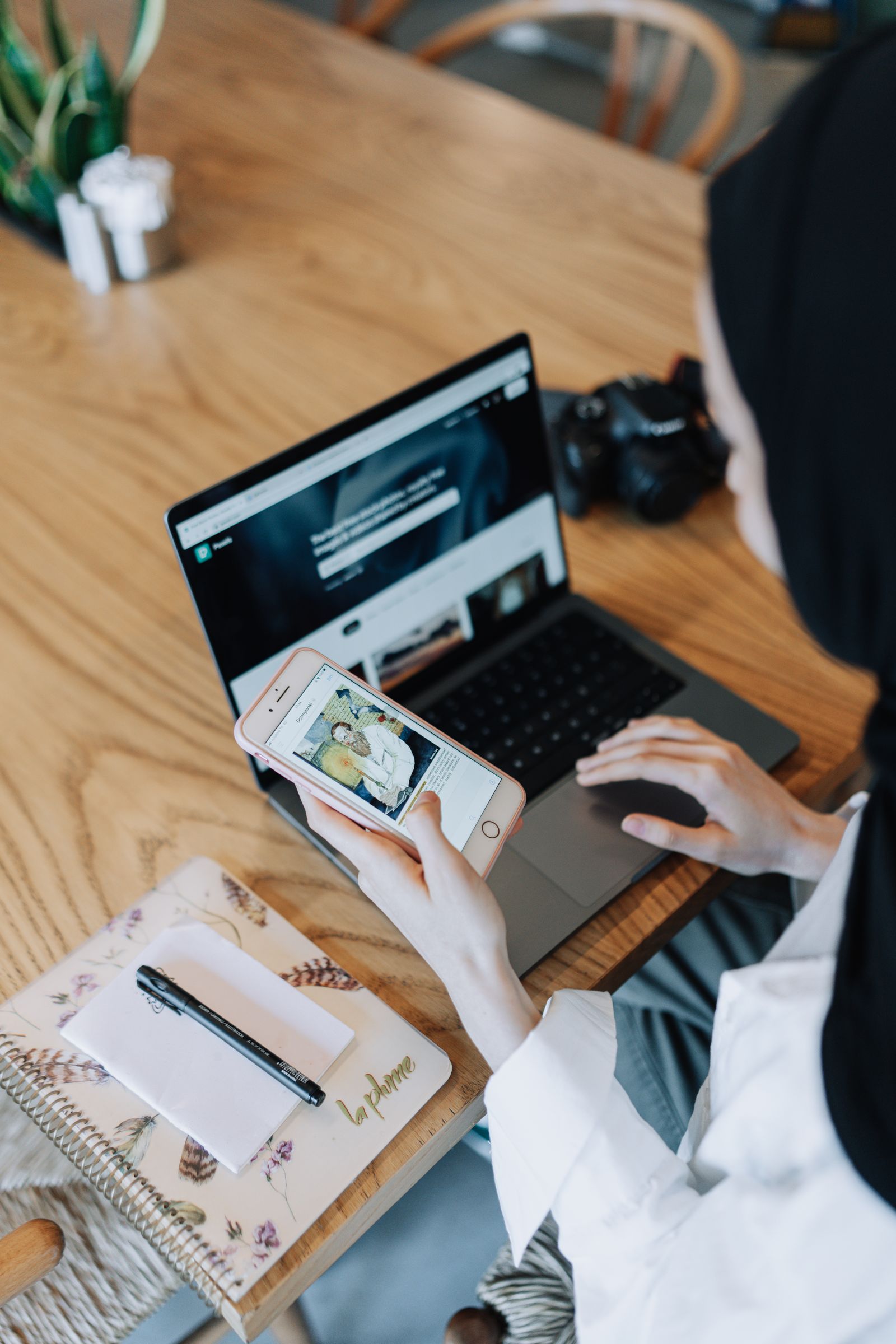 A creator working on their site and phone